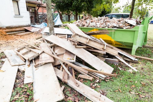Front view of a skip on a street used by a skip hire company